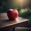 An apple on a table with a green leaf on it 976541 946